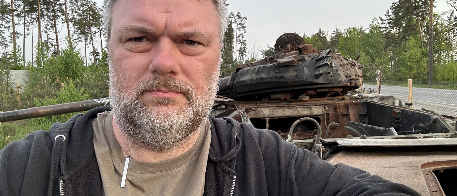 Standing next to a destroyed russian tank